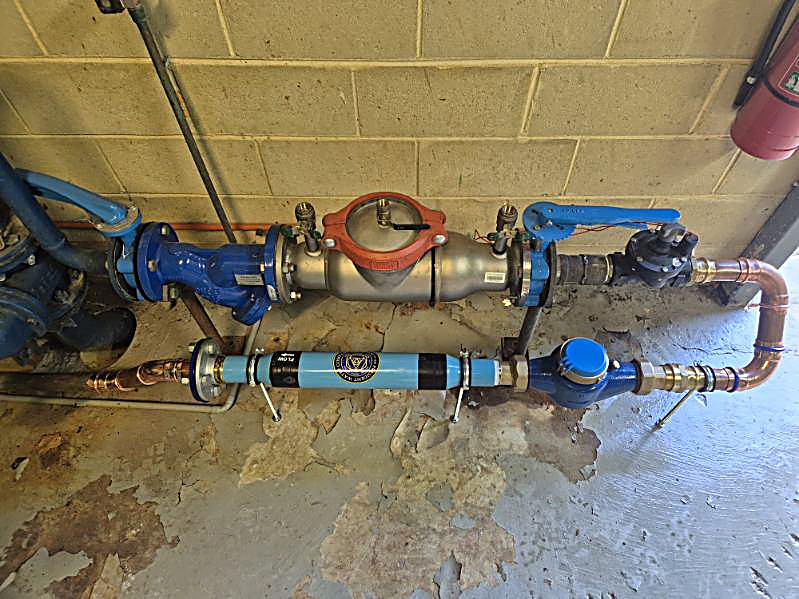 PW200 and new meter installed beside the backflow preventer