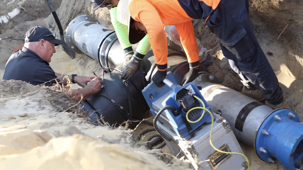 Crew electrofusion welding the units into the polyethylene mainline